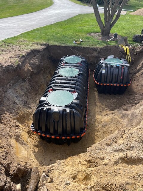 Twin septic tanks with green access lids ready for connection